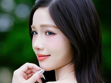 Young woman with dark hair smiling outdo