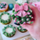 Thumbnail: Six Christmas cupcakes decorated with buttercream wreaths, pink bows, holly leaves, and festive detailing.
