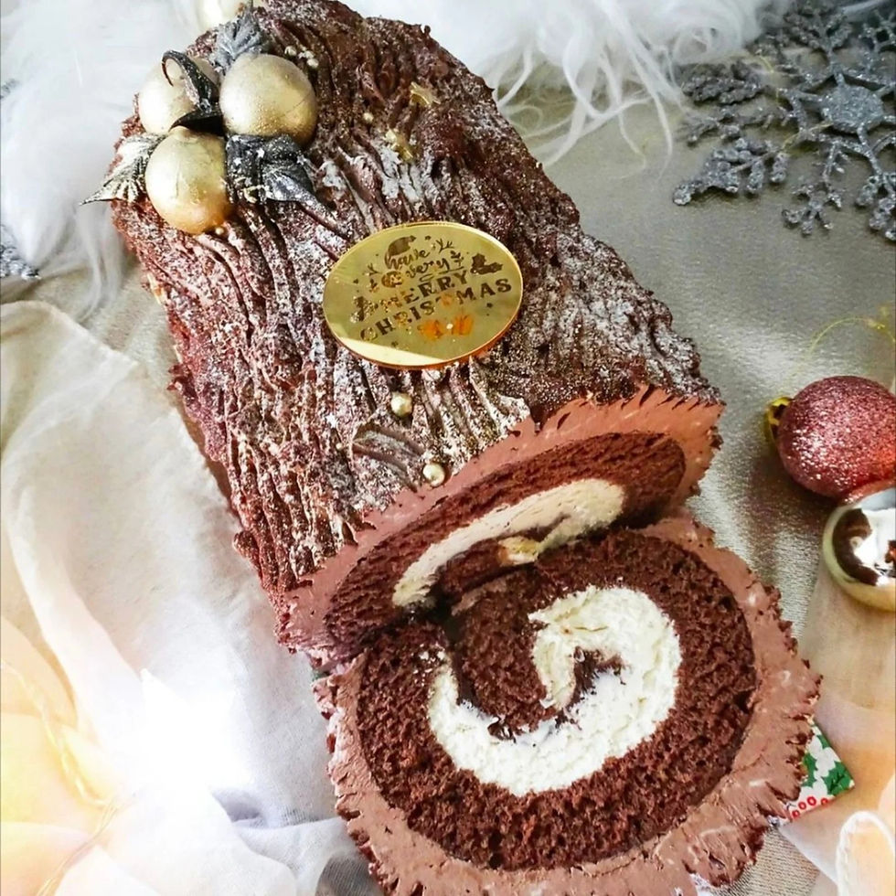 A slice of a luxury Yule log decorated with gold chocolates and decorations