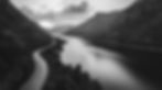 bthompson63097_a_road_along_a_calm_mountainside_river_winding_i_2a547ed8-1f57-4854-b336-04