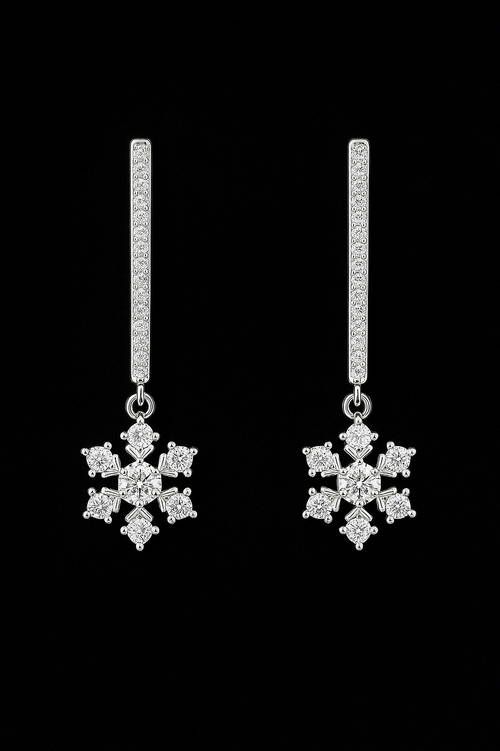 Dazzling diamond snowflake earrings hanging against a black background, simple elegance.