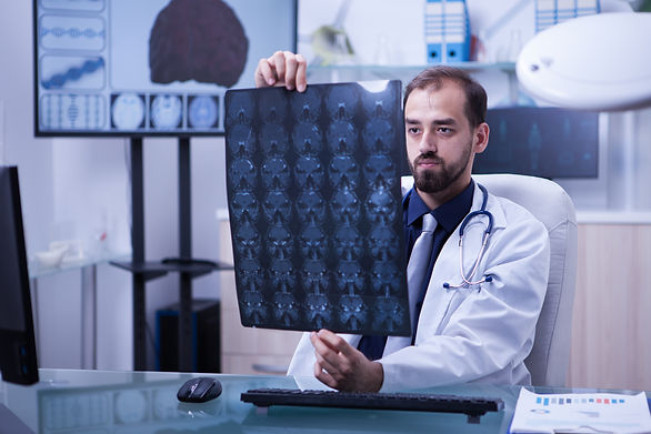 27portrait-young-ambitious-doctor-examining-brain-x-ray-doctor-holding-brain-radiograph.jp
