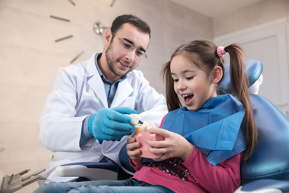 young-caucasian-girl-visiting-dentist-s-office.jpg