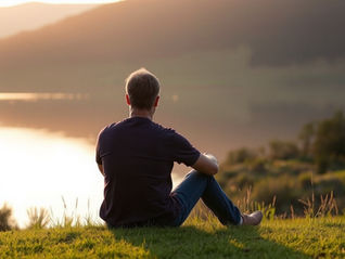 Contemplating why God said no sitting by a lake at sunrise