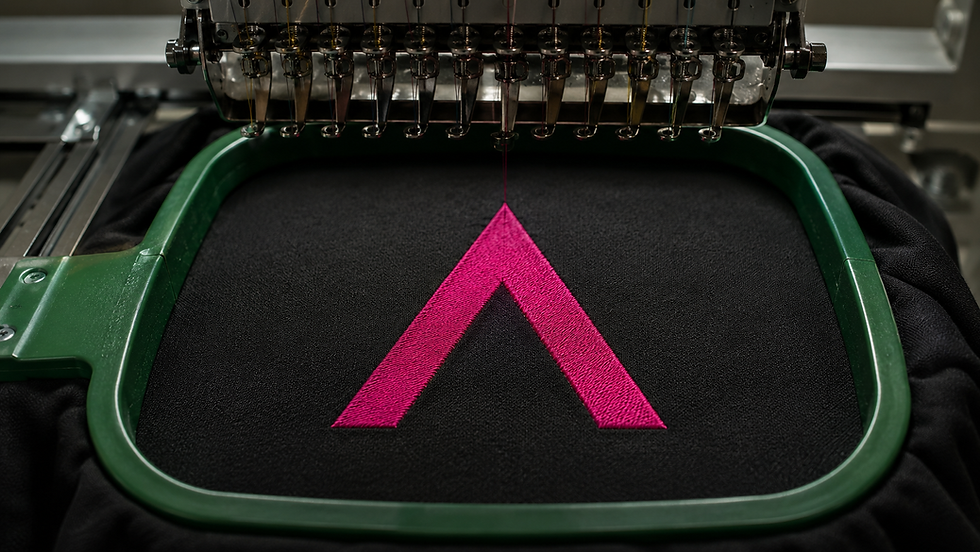Pink logo embroidered onto black workwear fabric.