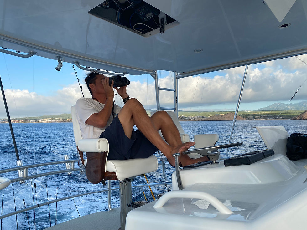 Captain Will from Off The Grid Lifestyle, observing the beauty of the ocean while driving his boat