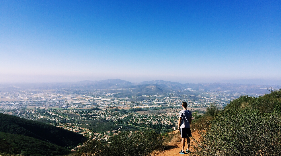 man-enjoying-the-view-from-a-mountain-trail