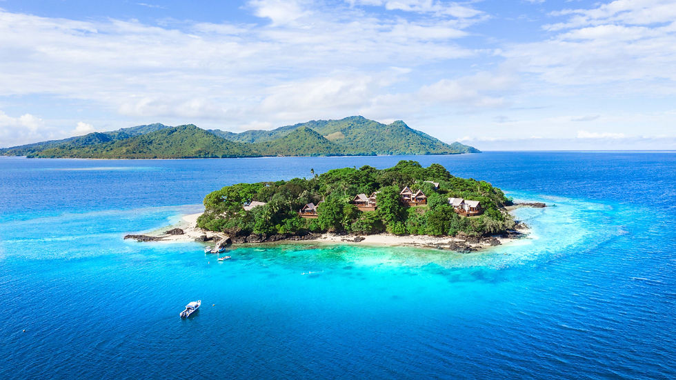 Tropical Fiji island with lush greenery, sandy beach, and several huts. Surrounded by clear turquoise water. A boat floats nearby. Peaceful vibe.