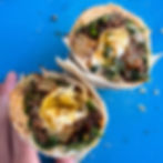 Chorizo breakfast burrito with a potatoes, a fried egg & spinach
