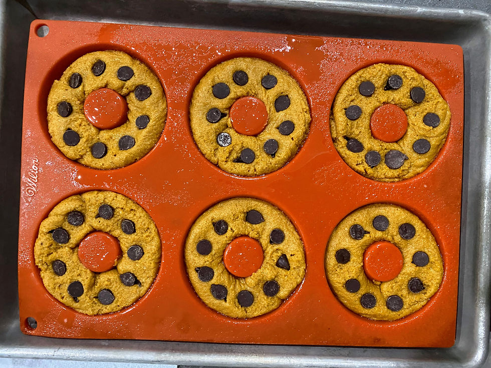 Pumpkin donuts with chocolate chips in baking molds