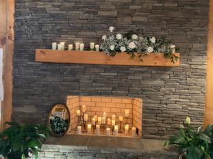 fireplace with candles at flowers at Riverain Farm in Greenville, SC