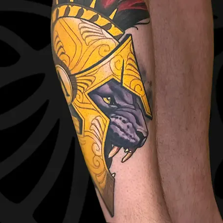 Neo-traditional color Spartan panther leg tattoo in Tel Aviv.
