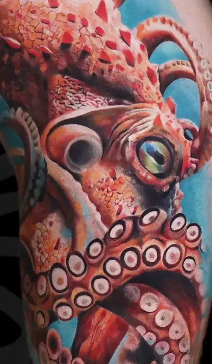 Realistic color octopus thigh tattoo in Tel Aviv.