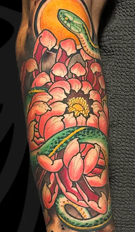 Neo-Japanese Irezumi chrysanthemum and snake arm tattoo in Tel Aviv.