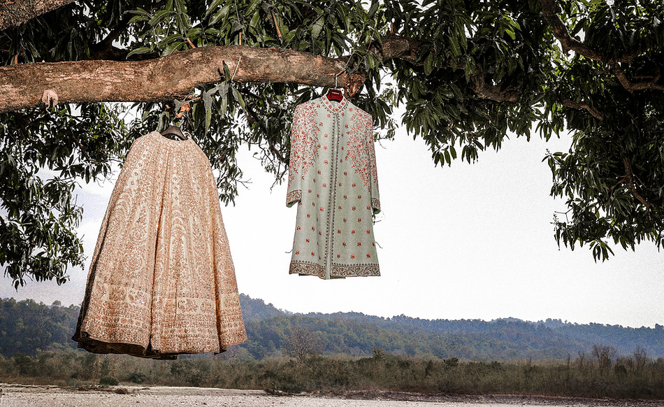 Elegant portrait showcasing the stunning wedding outfits of the bride and groom.