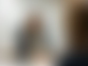 a woman in glasses shaking hands with another woman