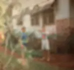 Sam and Jordan playing outdoors with bow and arrow