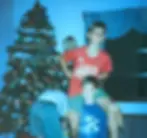 Sam and Jordan playfully posing by Christmas tree