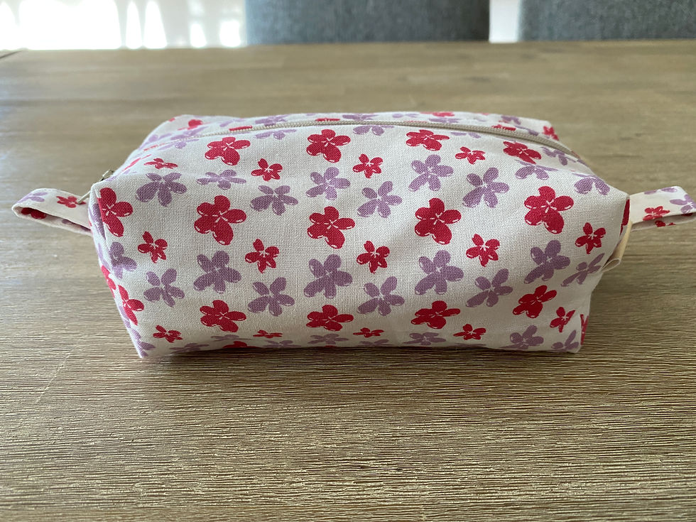 Thumbnail: Boxed cornered zipper pouch in pink and purple flowered cotton fabric