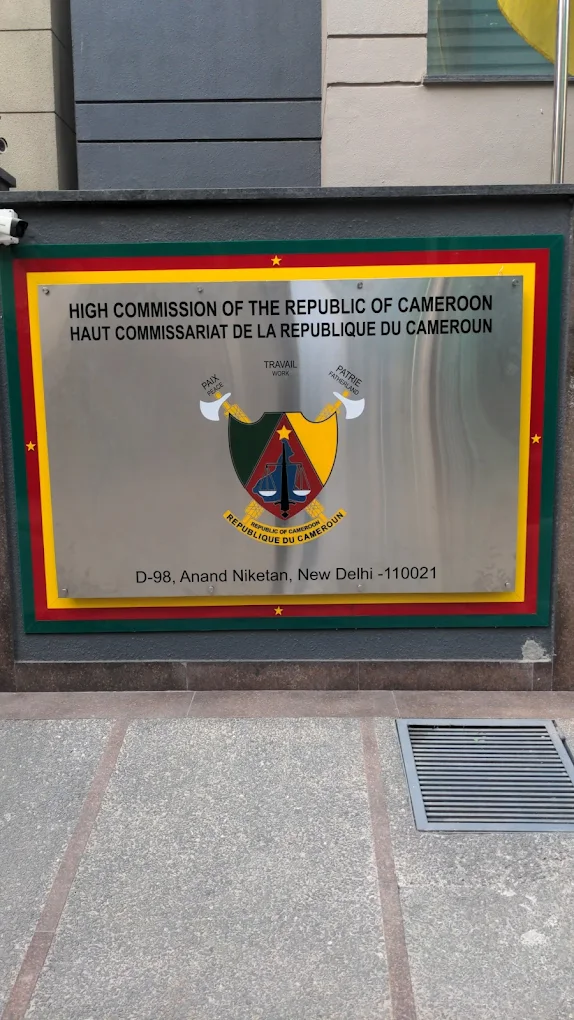 Sign for the High Commission of the Republic of Cameroon in New Delhi, with a colorful emblem and text in English and French.