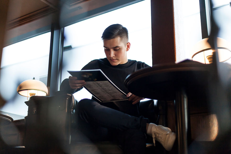 young-man-reading-menu-cafe.jpg
