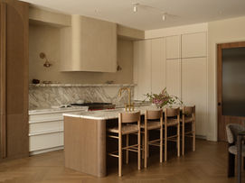 Warm and neutral-toned kitchen with a ample amount of hidden storage