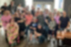 Large group of smiling people at a community event.