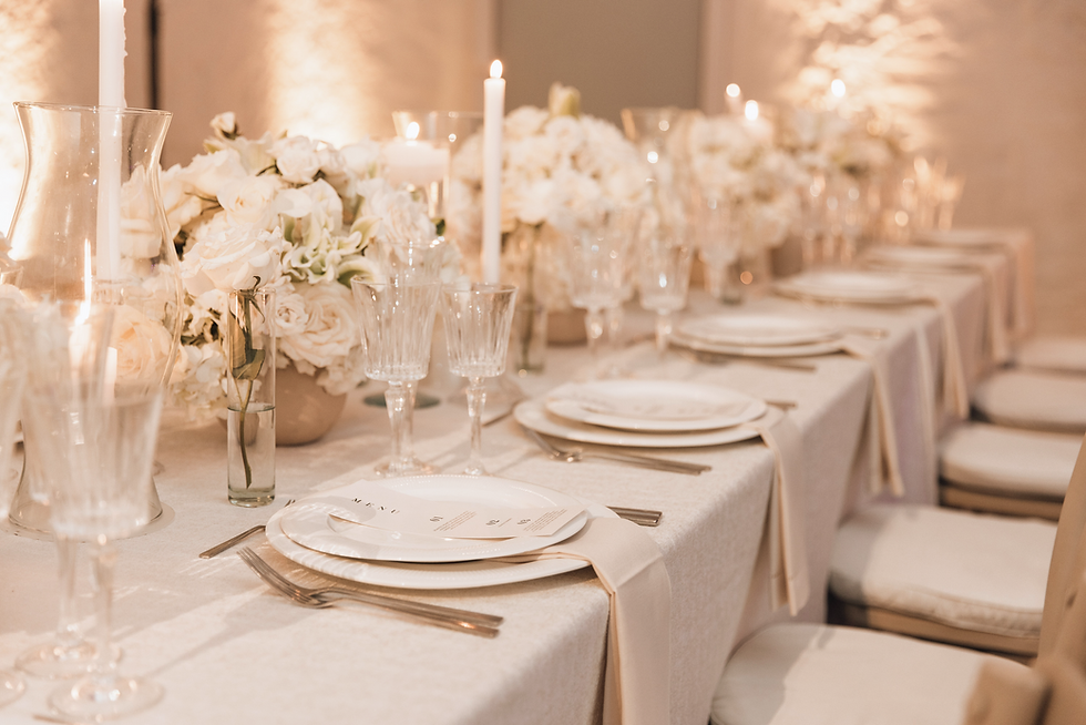 An elegant white wedding with soft white floral arrangements, delicate lace accents, and s
