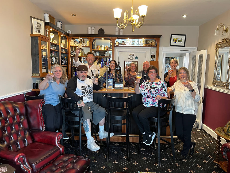 Group of people gathered at bar giving thumbs up. Essential Ireland Tours
