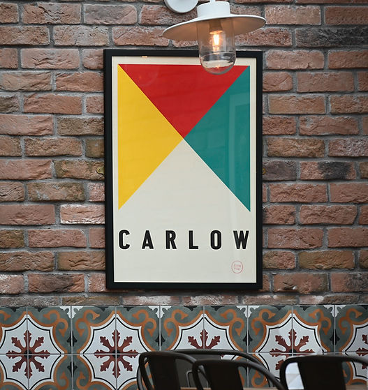 Poster with Carlow text on a brick wall with colorful design. Carpenter'sBarLounge