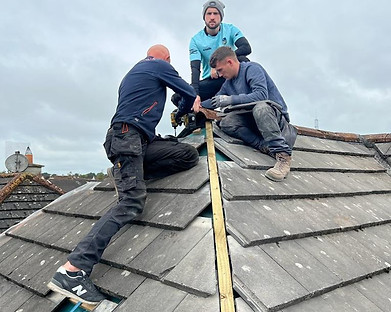 Roofers repairing a roof