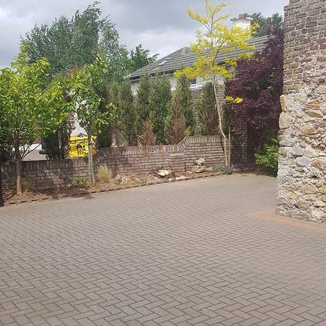 Landscaped garden with paved driveway