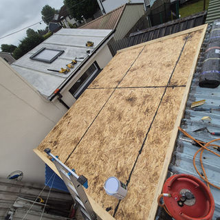 Roof repair: Plywood sheets replacing damaged roof section