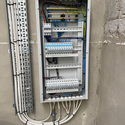 Electrical panel with wires and circuit breakers. Metris Contractor Services.