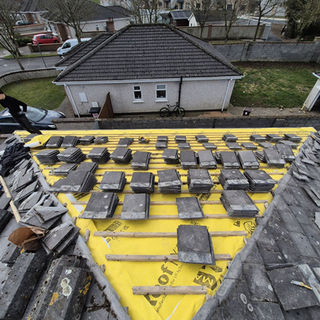 Roof repair in progress, new tiles ready