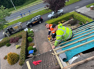 Roofers repairing a roof