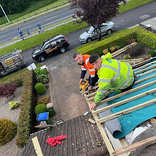 Roofers repairing a roof