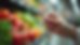 Eye-level view of a person holding a tirzepatide injection pen with a blurred background of healthy food