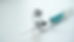 Close-up view of a vial labeled MOTS-c 10MG with a syringe on a white surface