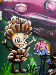 Ein Tannenzapfen-männchen gesprüht mit Graffiti