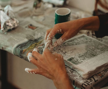 Plaster bandage sculptures with hands and newspaper