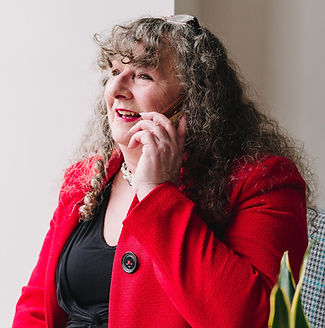 Debbie wearing a red top and on the phone