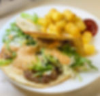 smash burger taco with copycat mac sauce on a white plate with toasted tater tots