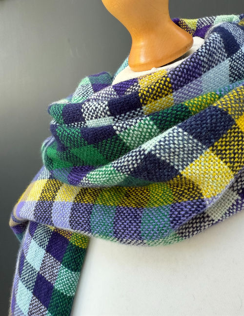 Thumbnail: Close view of handwoven purple checked merino fabric showing the bold colour pattern
