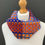Thumbnail: Vibrant blue and orange woven patterned lambswool cowl scarf wrapped around the models neck