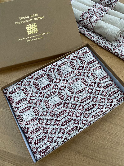 Thumbnail: Handwoven red and ecru Overshot table runner in gold-embossed branded gift box with tissue paper — luxury homeware gift by