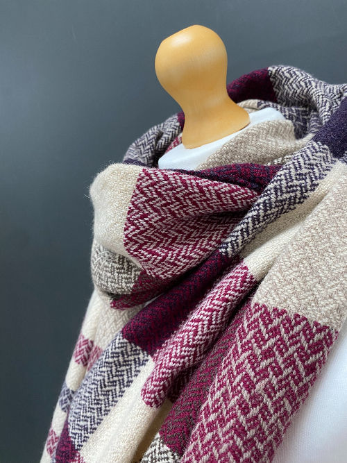 Thumbnail: close up of handwoven merino lambswool pink, plum and beige wool scarf