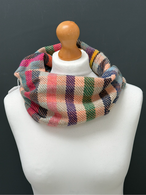 beige, blue, orange and green striped snood  scarf on a mannequin