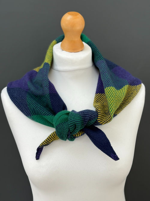 Thumbnail: purple, yellow, green and navy triangle scarf on a mannequin