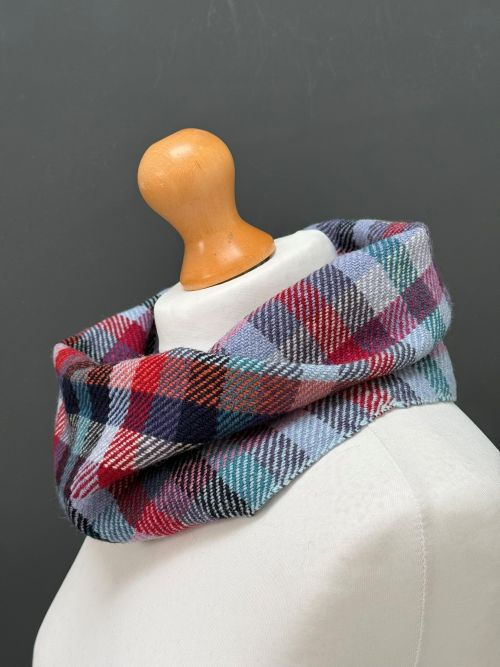 Thumbnail: side ways view of a handwoven checked green and pink snood scarf